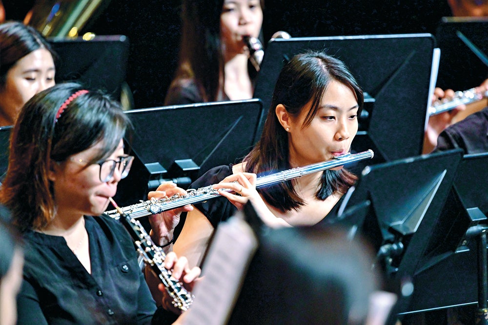 Generations of NUS Wind Symphony alumni performing together to honour their mentor.