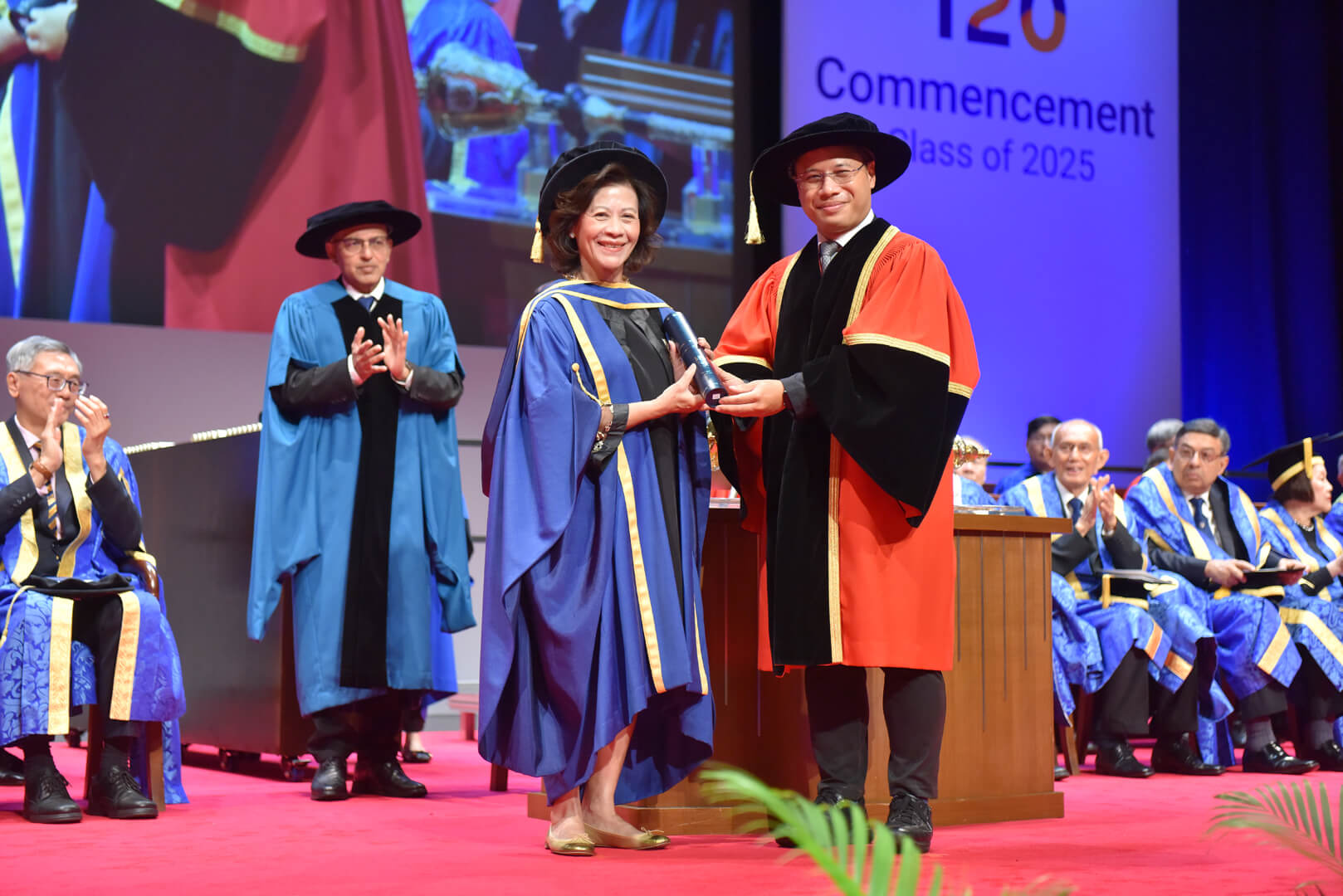 Dr Noeleen Heyzer receiving the honorary degree from Mr Desmond Lee, Minister for Education and Minister-in-Charge of Social Services Integration, who presided over the conferment ceremony.
