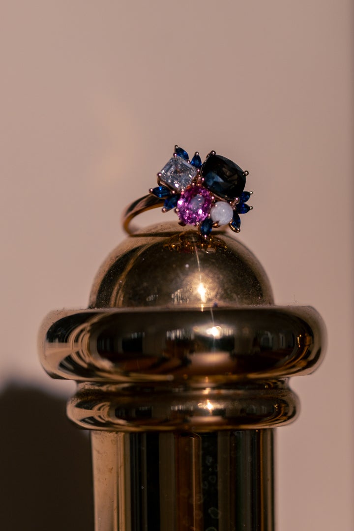 A bespoke ring, centred around a breastmilk charm and family birthstones.
